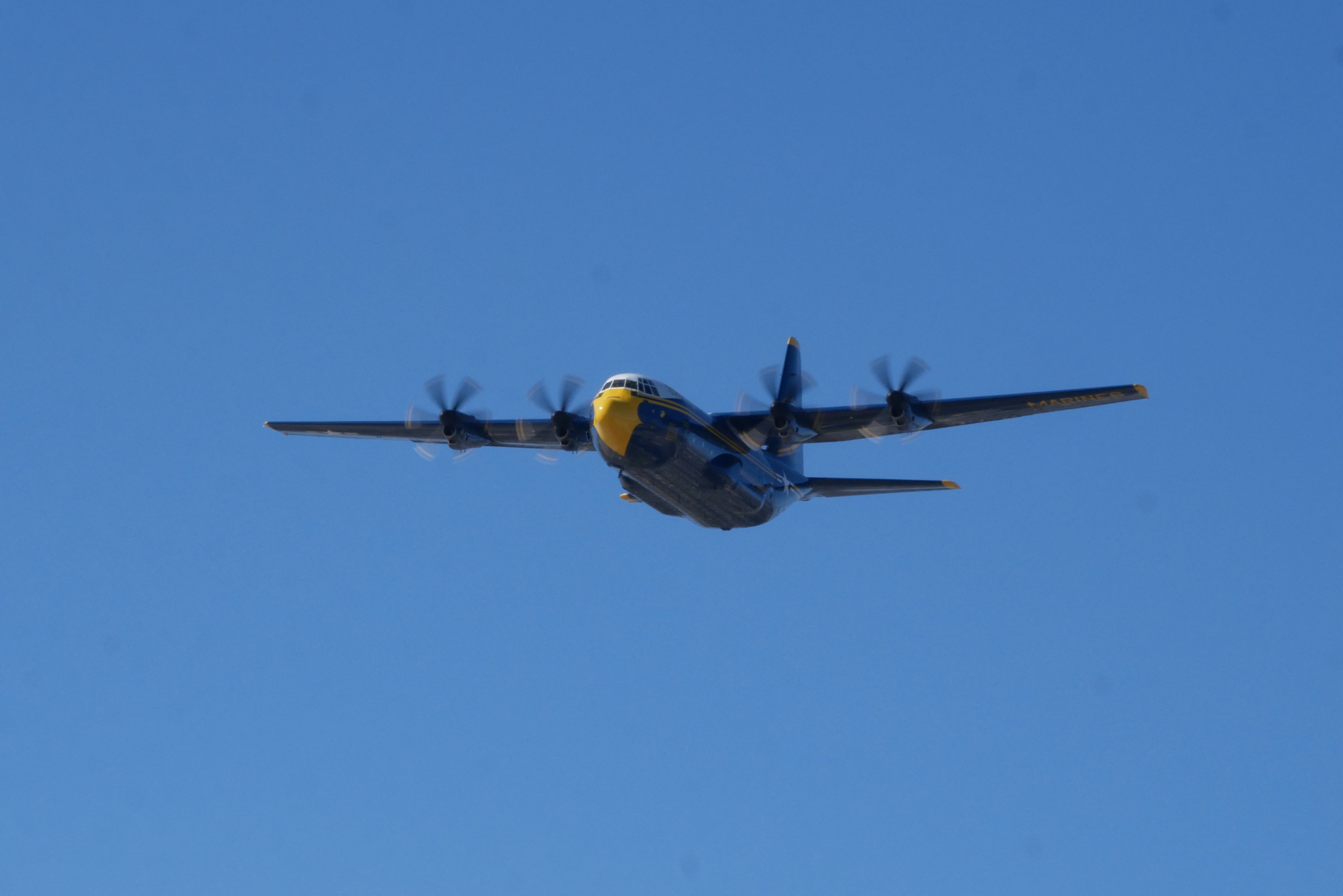 A shot of a large blue plane flying.
